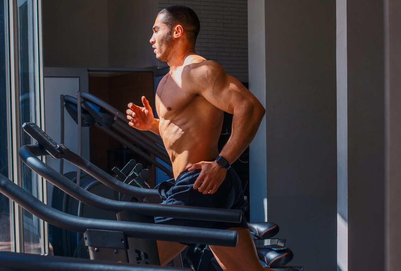 a man running on a treadmill in a gym